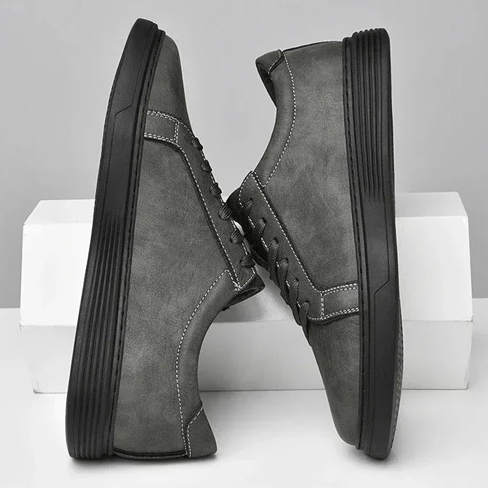 Rovelli stylish gray casual sneakers with black soles and white stitching on display