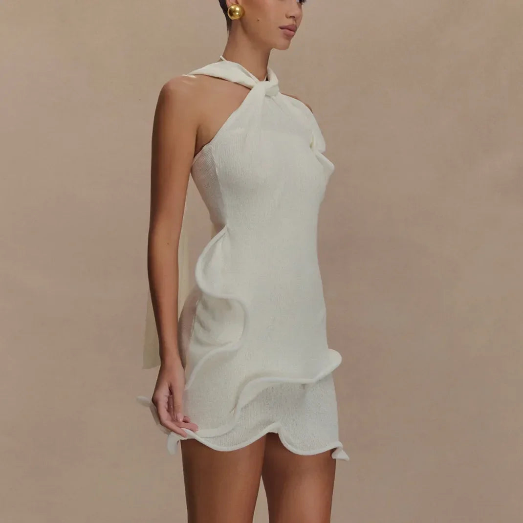 Rovelli elegant white halter mini dress with wavy ruffle detail on neutral background