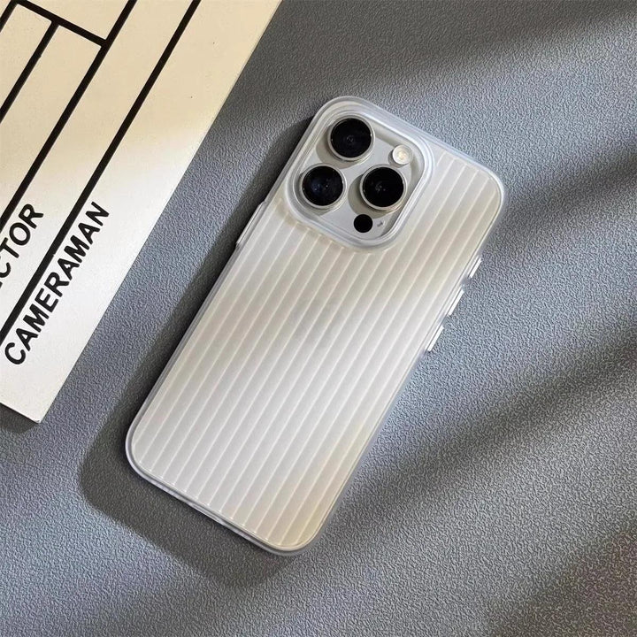A silver smartphone with a slim lightweight design and a scratch-resistant cover lies on a textured gray surface next to a white sheet of paper labeled CAMERAMAN in black text.