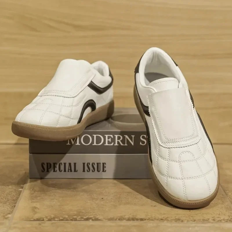Rovelli white slip-on sneakers with gum sole and black accents on display box