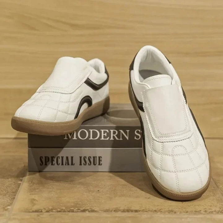 Rovelli white slip-on sneakers with gum sole and black accents on display box
