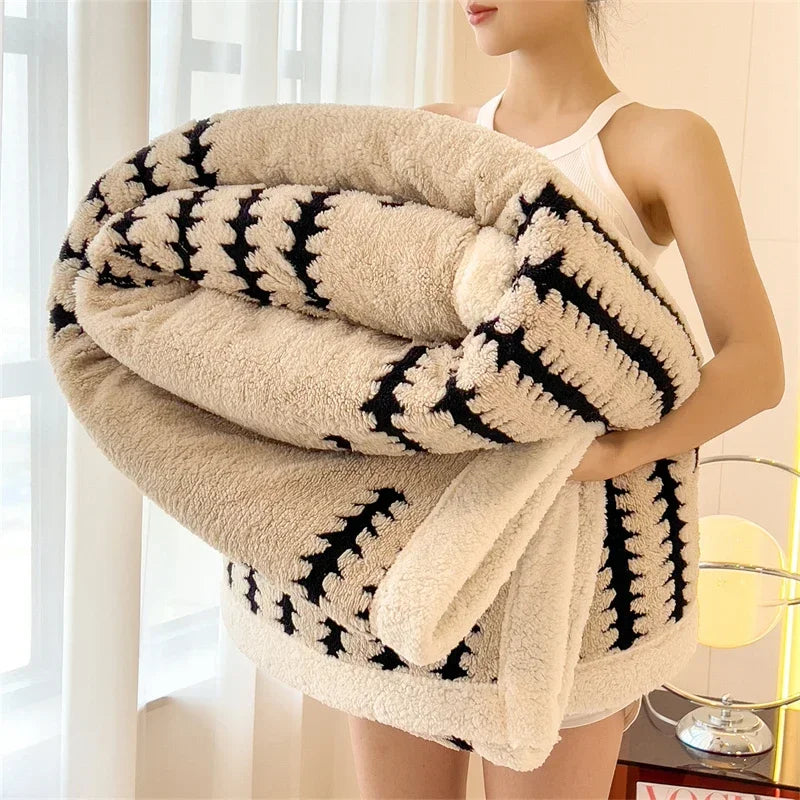 Woman holding large beige and black geometric patterned cozy blanket, Rovelli home decor