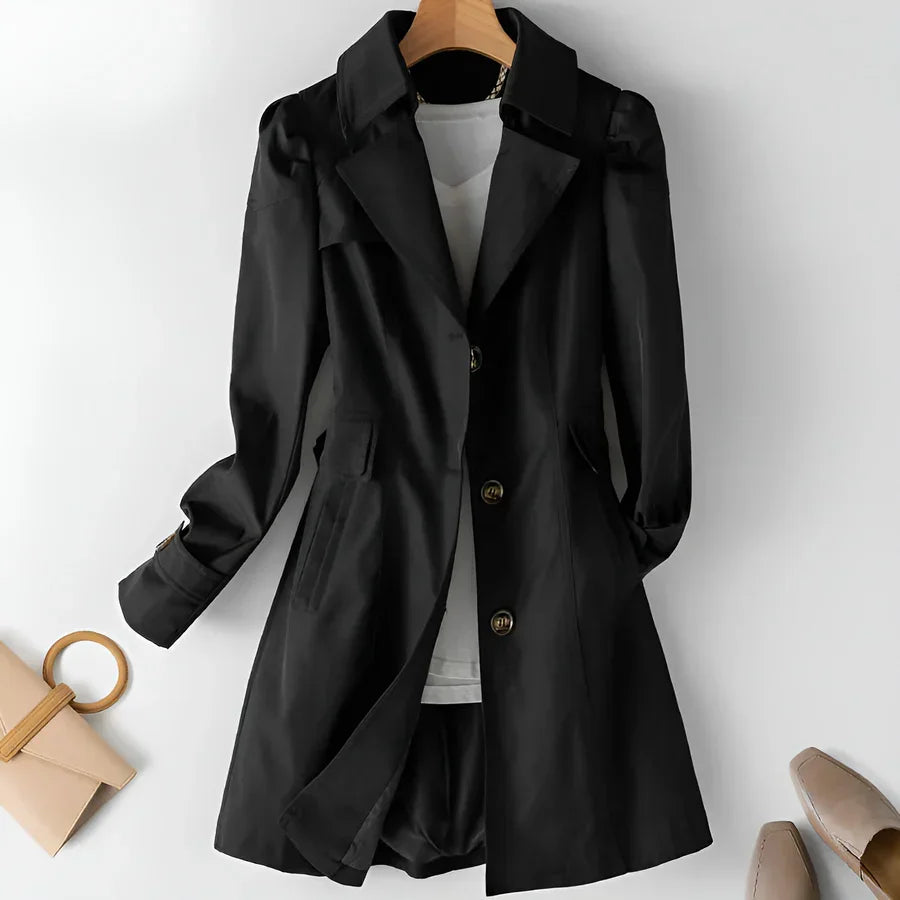Rovelli black trench coat with gold buttons, white top, and beige accessories on hanger