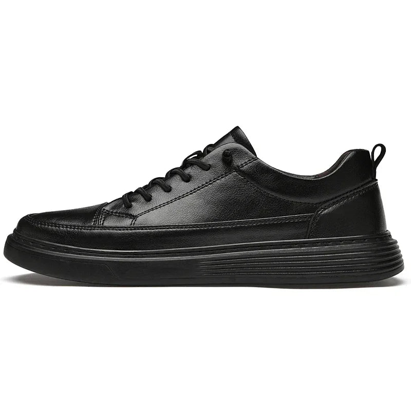 A black genuine leather sneaker with a low-top design, black laces, textured rubber sole, and pull tab at the heel, shown in a side profile view against a white background.