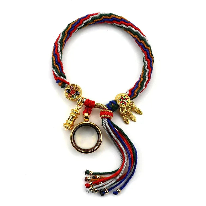 A colorful braided bracelet with adjustable sizing, gold charms, a circular ring, and tassels. Featuring red, green, blue, white, and black threads, the intricate charms highlight exquisite Tibetan craftsmanship.