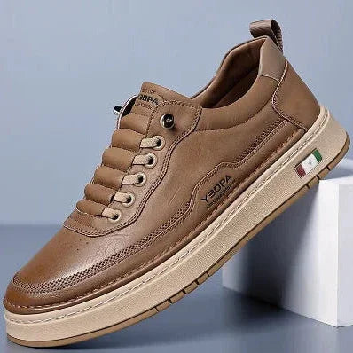 Rovelli brown leather sneaker with beige sole and Italian flag detail, displayed on pedestal