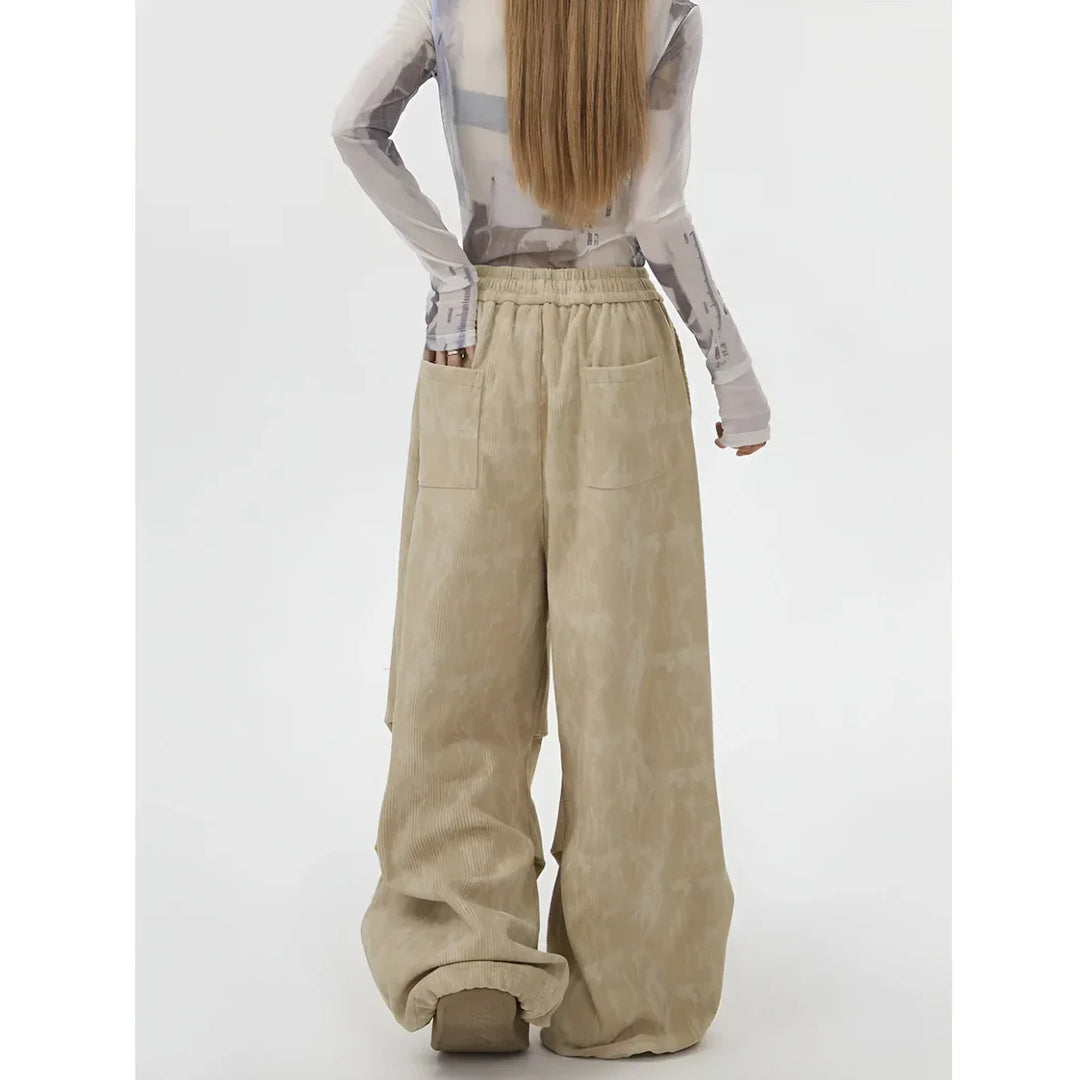 Model wearing beige wide-leg corduroy pants with back pockets, Rovelli fashion