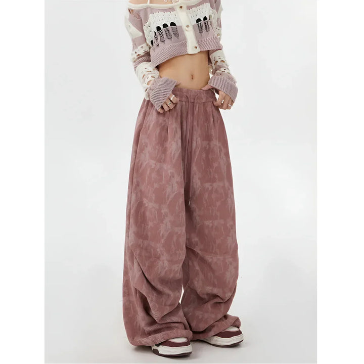 Model wearing pink wide leg pants and cropped knit sweater, Rovelli fashion