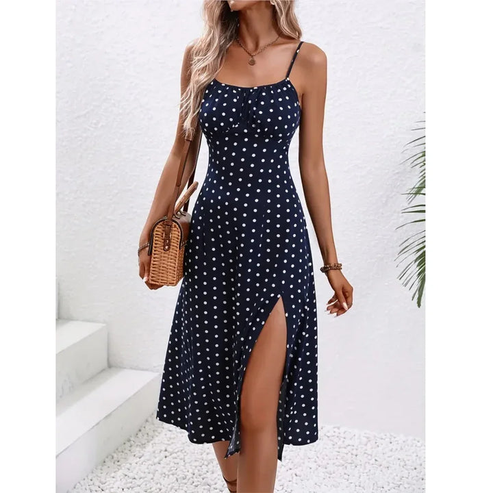 Woman in navy blue polka dot midi dress with side slit, summer fashion by Rovelli