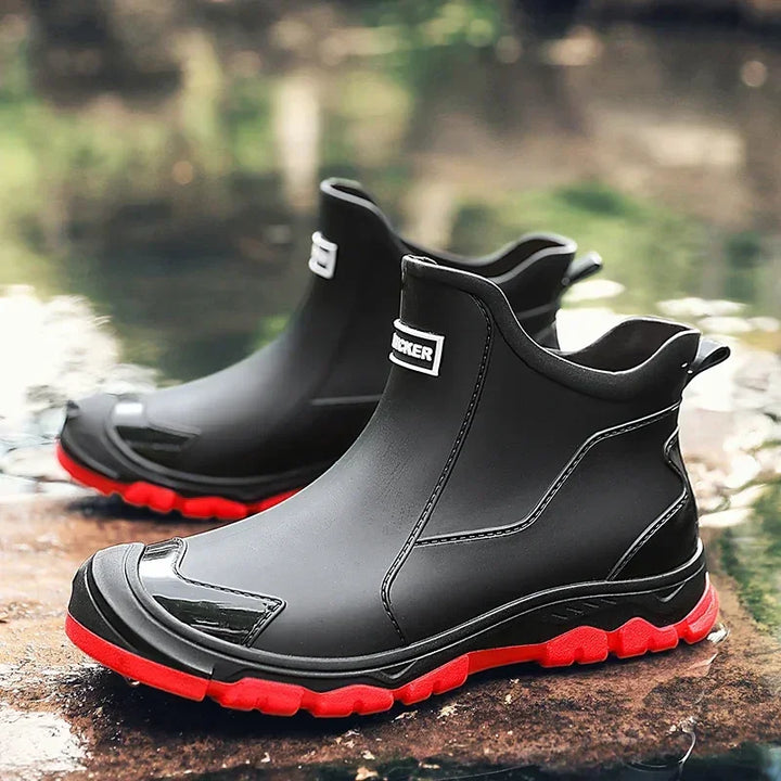 Rovelli black waterproof ankle boots with red soles, outdoor setting, rugged footwear