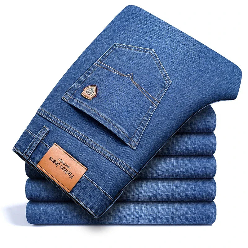 Stack of folded blue Rovelli jeans with leather patch and pocket detail