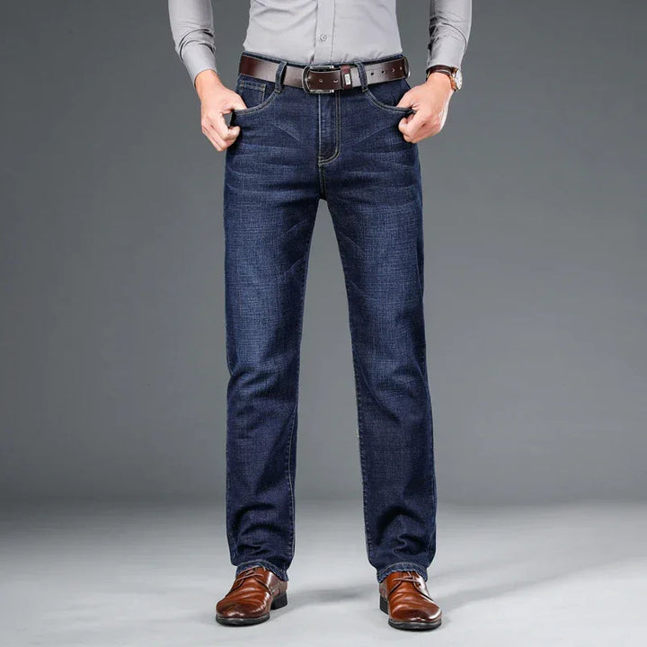 Man wearing dark blue straight-leg jeans, brown belt, and brown leather shoes, Rovelli