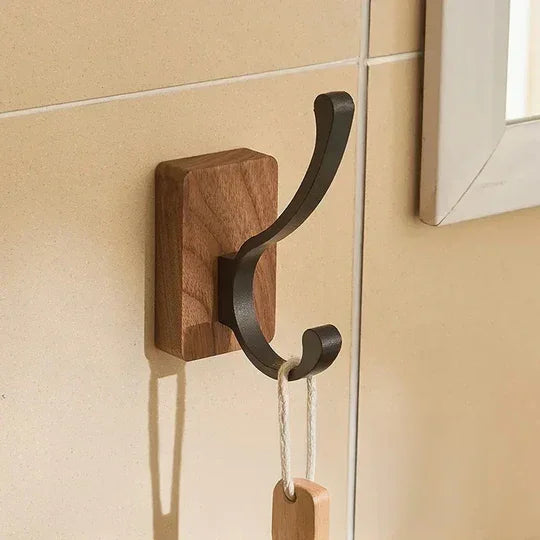 Wood and metal wall hook mounted on beige tile, modern home decor by Rovelli