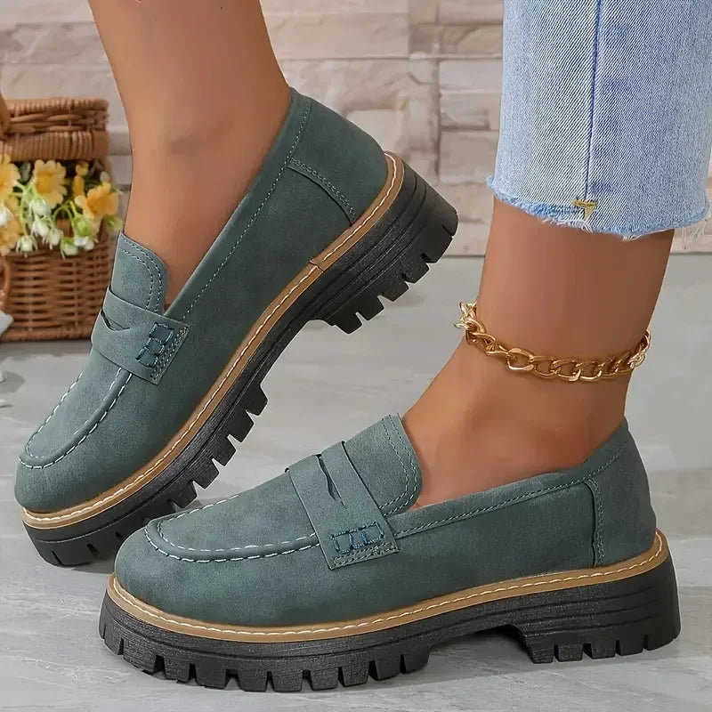 Women's chunky sole green loafers from Rovelli, styled with gold anklet and rolled jeans