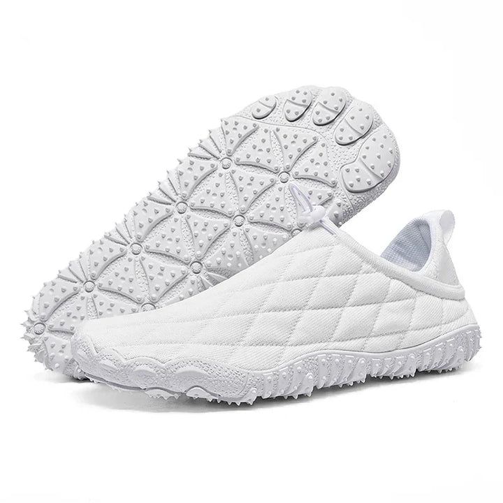 Rovelli white quilted slip-on sneakers with textured rubber sole on white background