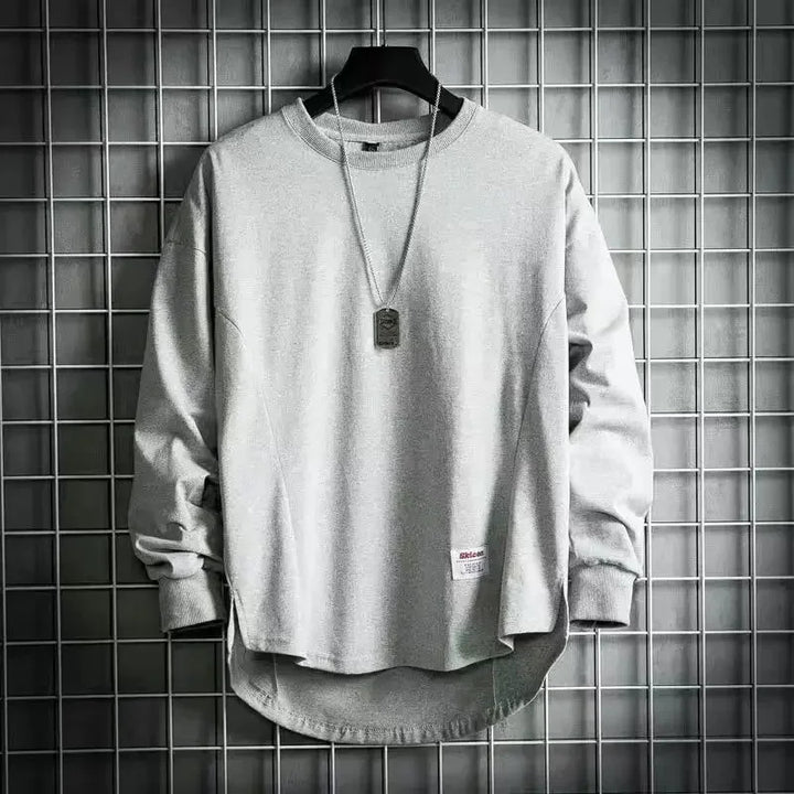 Rovelli light gray crewneck sweatshirt with necklace, displayed on hanger against grid wall.