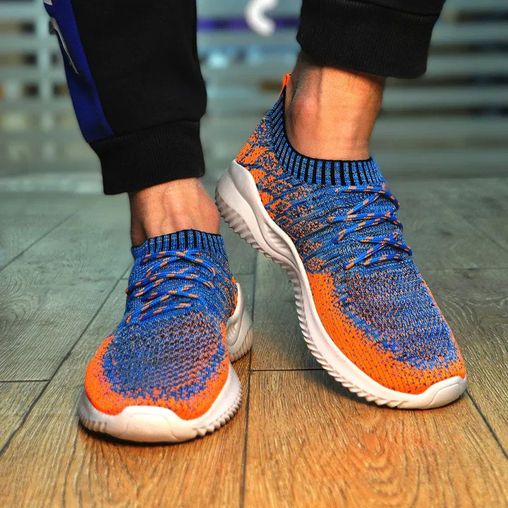 Rovelli blue and orange knit sneakers with white soles on wooden floor
