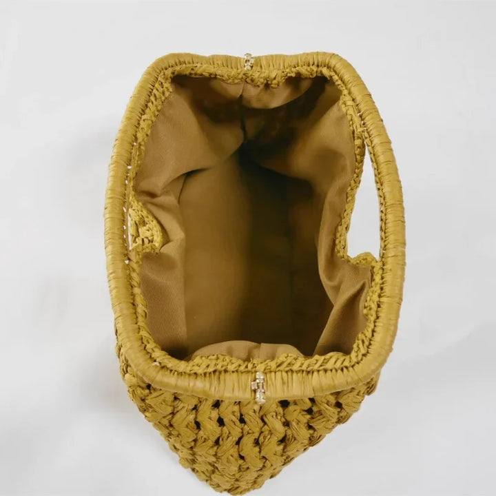 Top view of open woven straw handbag with fabric lining from Rovelli