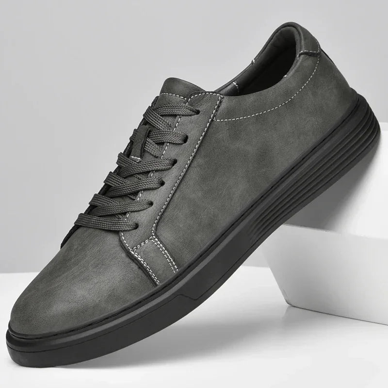 Rovelli grey casual sneaker with black sole and white stitching on white background