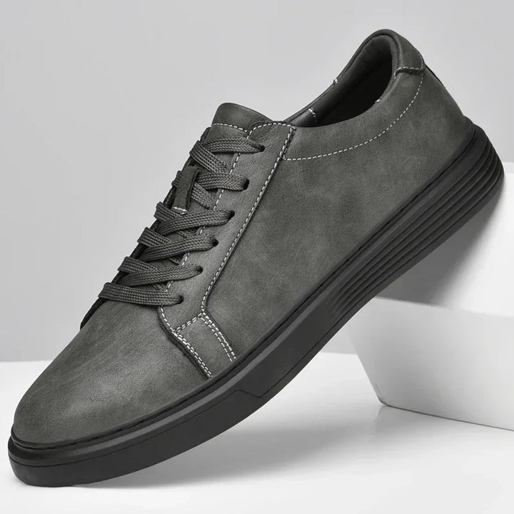 Rovelli grey casual sneaker with black sole and white stitching on white background
