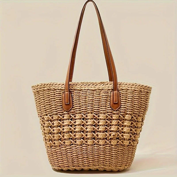 Rovelli woven straw tote bag with brown handles on neutral background