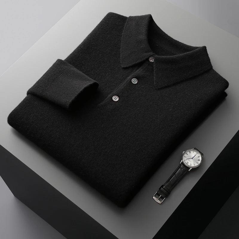 Folded black knit polo shirt with buttons and a silver wristwatch on a grey surface, Rovelli