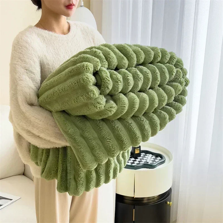 Woman holding large plush green blanket in modern living room, Rovelli home décor