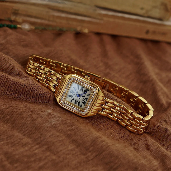 Rovelli gold women's wristwatch with diamond bezel and Roman numerals on brown fabric