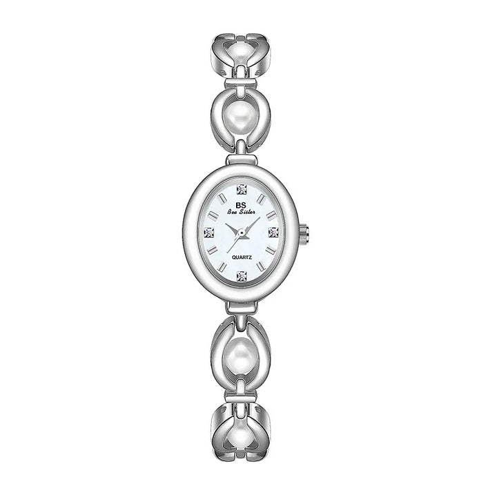 A silver womens wristwatch with an oval face, minimalist design, and a decorative band featuring heart-shaped links. The white dial has silver hour markers and hands, four small diamond accents, and reliable precision quartz movement.
