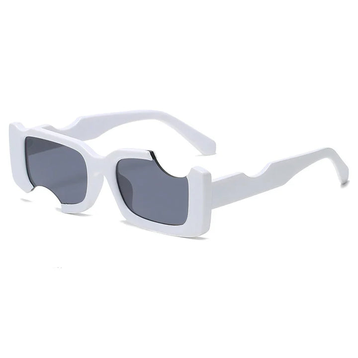 White, chunky, rectangular sunglasses with geometric frames and black-tinted lenses. The unique design features angular indents and bold shapes on the arms, adding a futuristic street style edge.