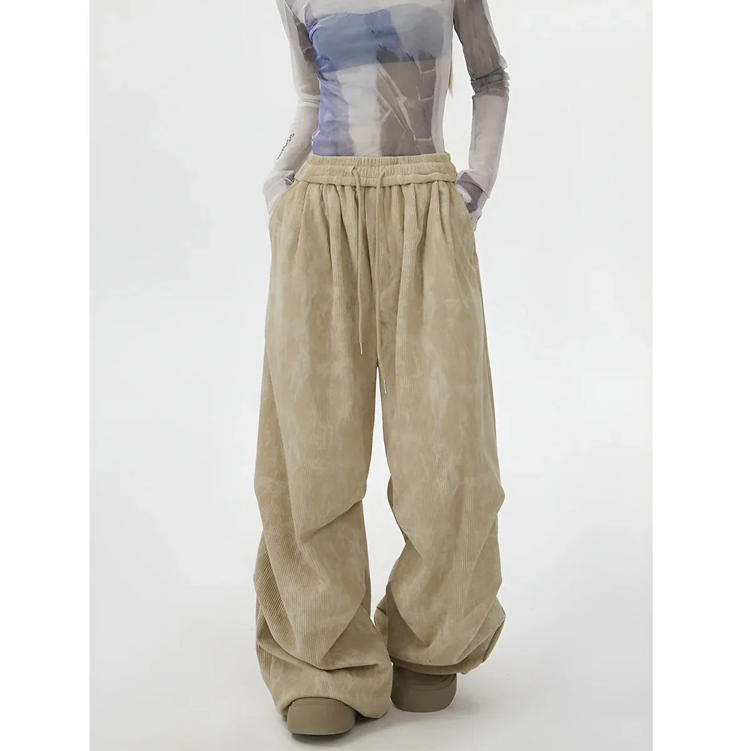 Rovelli wide-leg beige corduroy pants with drawstring waist, styled with sheer top