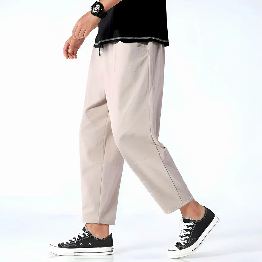 Rovelli beige casual pants for men, styled with black sneakers and a black top