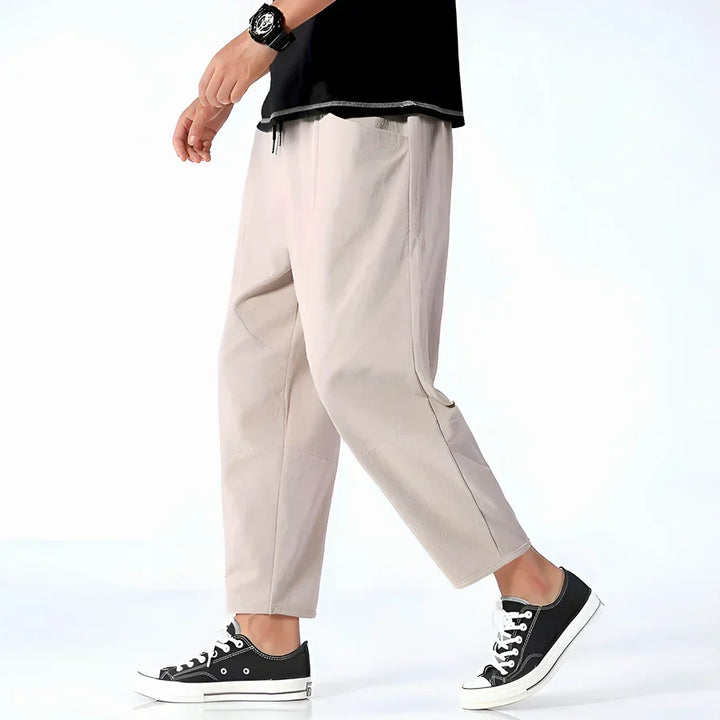Rovelli beige casual pants for men, styled with black sneakers and a black top