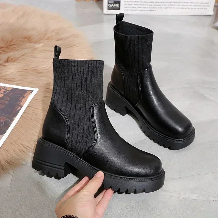 Rovelli black chunky platform ankle boots with ribbed knit upper on gray floor