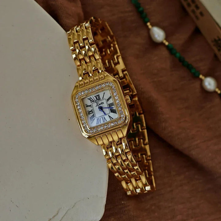 Rovelli gold square wristwatch with crystal bezel and Roman numeral dial on brown fabric