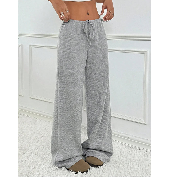 Rovelli gray wide-leg lounge pants with drawstring waist, modeled indoors on white rug
