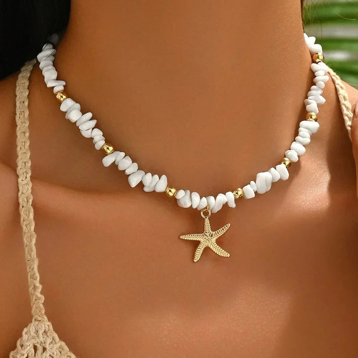 Rovelli beach choker necklace with white beads, gold accents, and starfish pendant