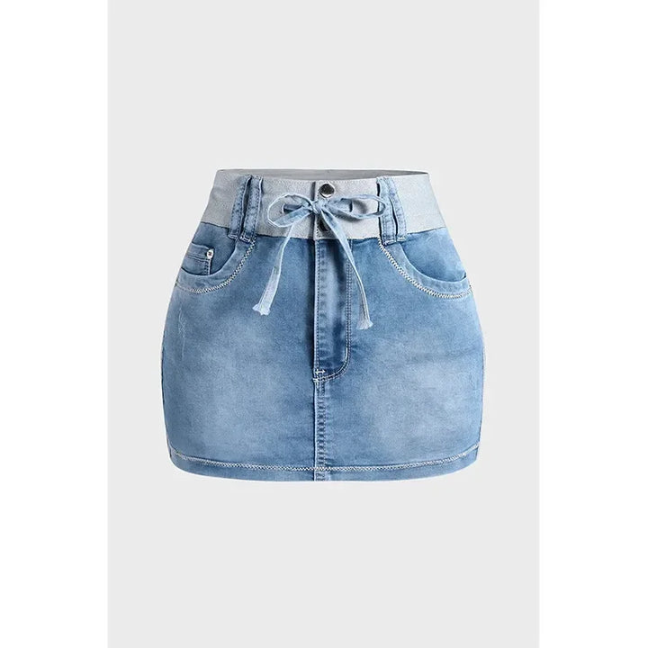 A light blue high waist denim skirt crafted from premium cotton, featuring a wide waistband, front pockets, button closure, and a matching denim tie belt, displayed against a plain white background.