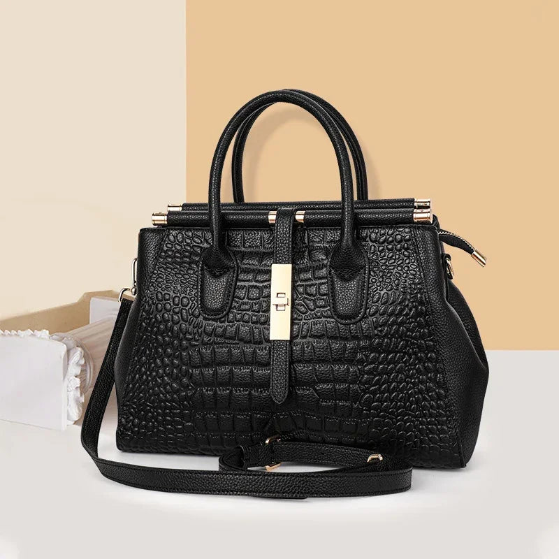 Rovelli black crocodile-embossed handbag with gold hardware and shoulder strap on neutral background