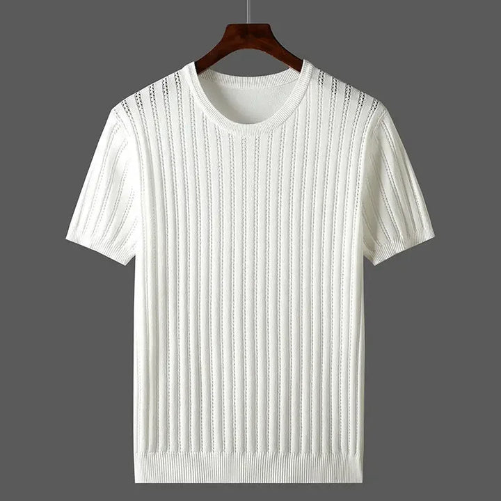A white short-sleeve knit sweater with vertical ribbed detailing and classic fit, displayed on a wooden hanger against a solid gray background.