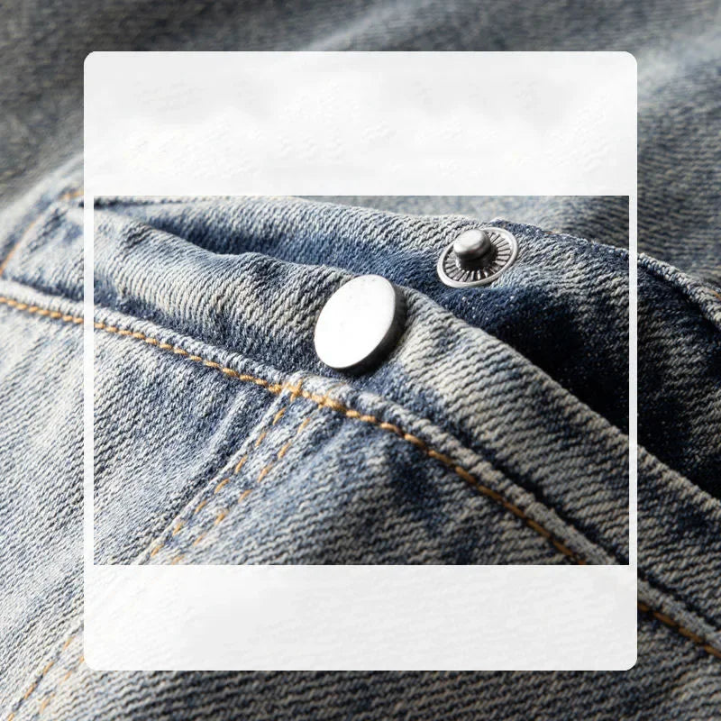 Close-up of classic fit blue denim jeans pocket with visible stitching and two metal rivets, one silver and one black, highlighting the stone washed texture and detail of the fabric.
