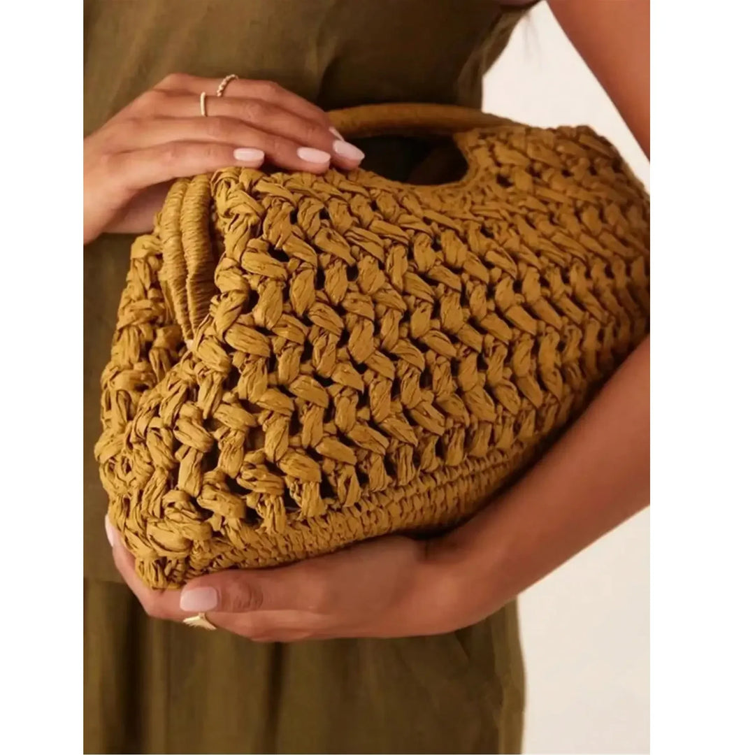 Woman holding a woven straw handbag, Rovelli fashion accessory, close-up style