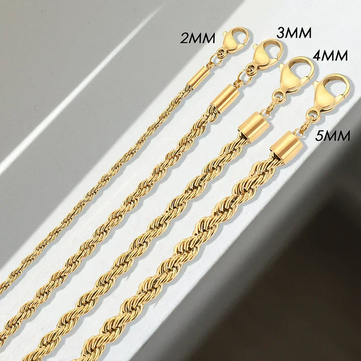 Four gold-toned rope chain necklaces of different thicknesses (2mm, 3mm, 4mm, and 5mm), each with a lobster clasp, are displayed parallel to each other on a white and grey surface. Made from non-fading materials for lasting shine.