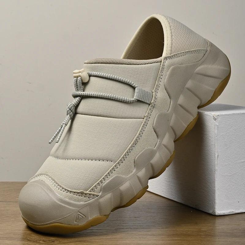 Rovelli beige slip-on sneaker with thick sole and toggle laces on wooden surface