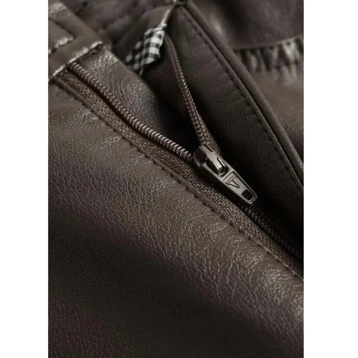 Close-up of brown leather jacket zipper with textured stitching, Rovelli fashion detail