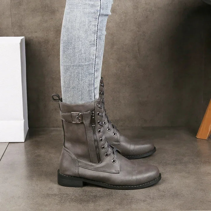 Gray lace-up combat boots with side zipper worn with light wash skinny jeans, Rovelli shoes