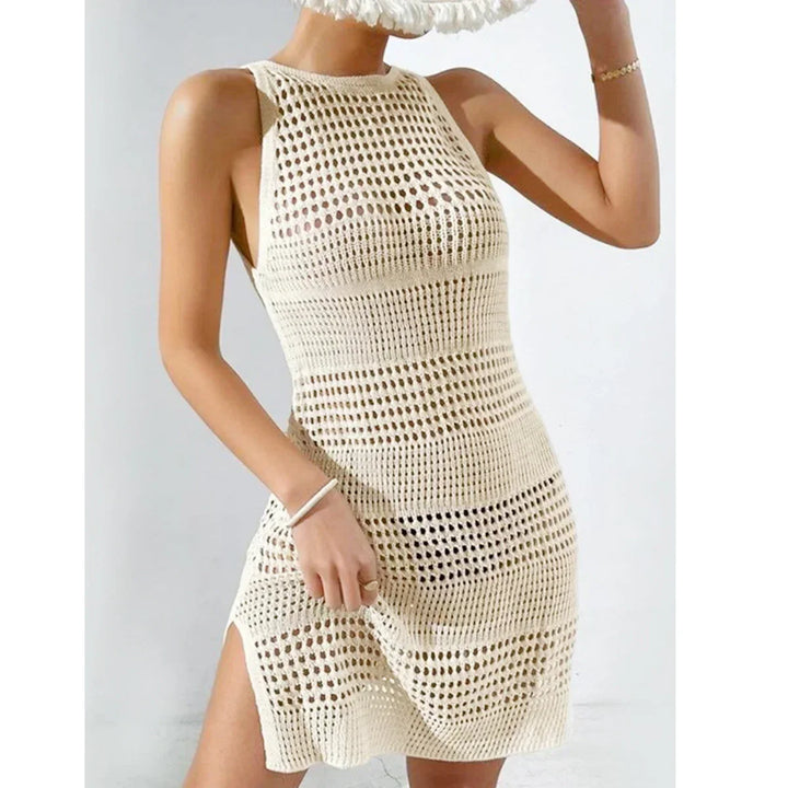 Woman wearing sleeveless cream crochet mini dress, Rovelli fashion summer outfit