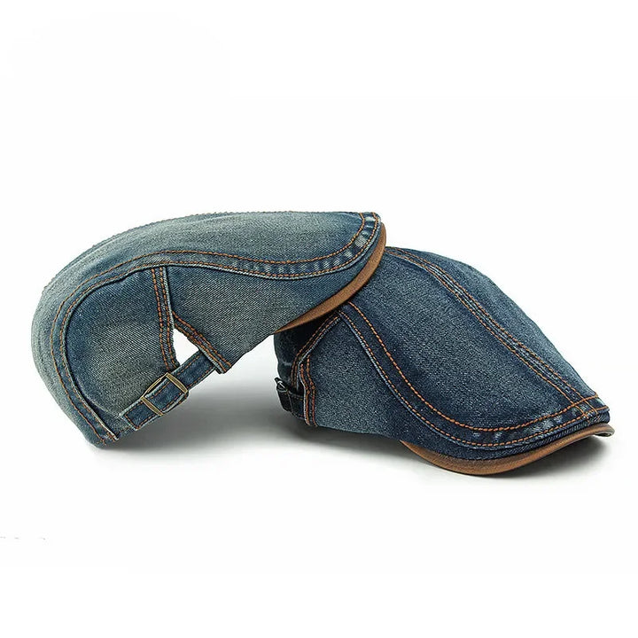 Two cotton denim newsboy caps with brown stitching and trim, one upright and the other positioned upside down, set against a white background—perfect for casual style and sun protection.