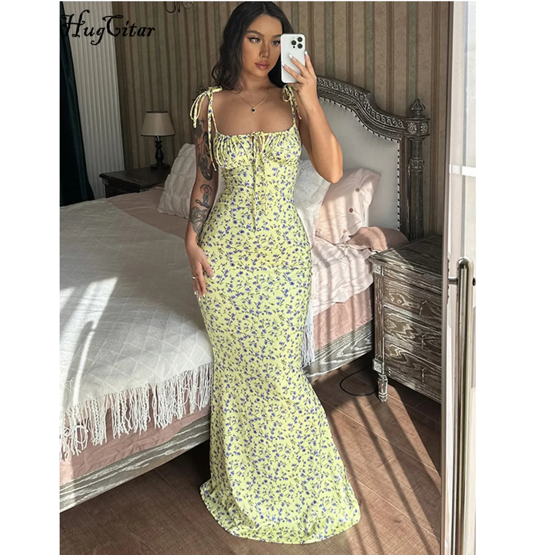 Woman in yellow floral maxi dress taking mirror selfie in elegant bedroom, Rovelli fashion
