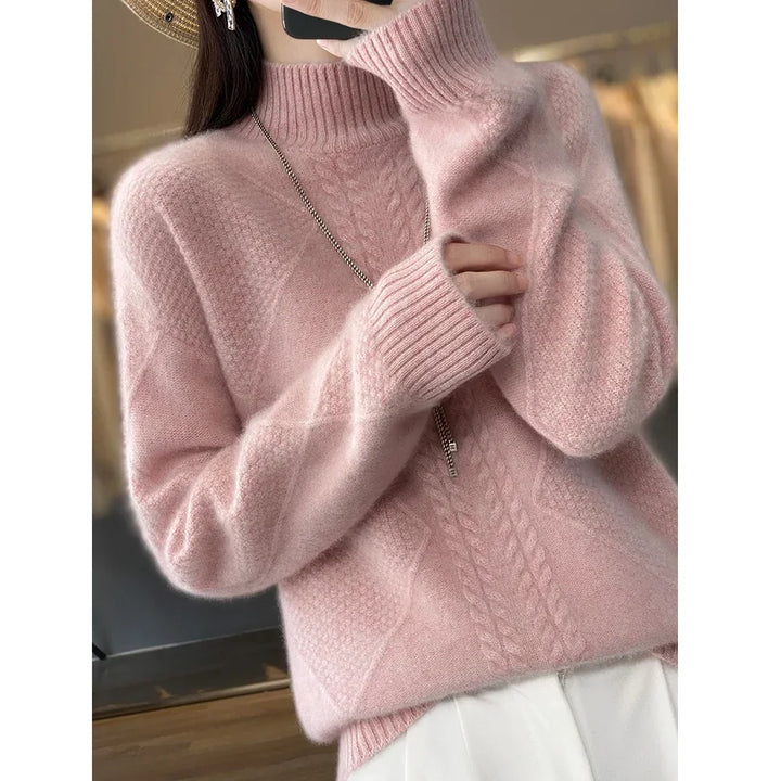 Woman wearing a soft pink cable knit sweater from Rovelli, cozy winter fashion style